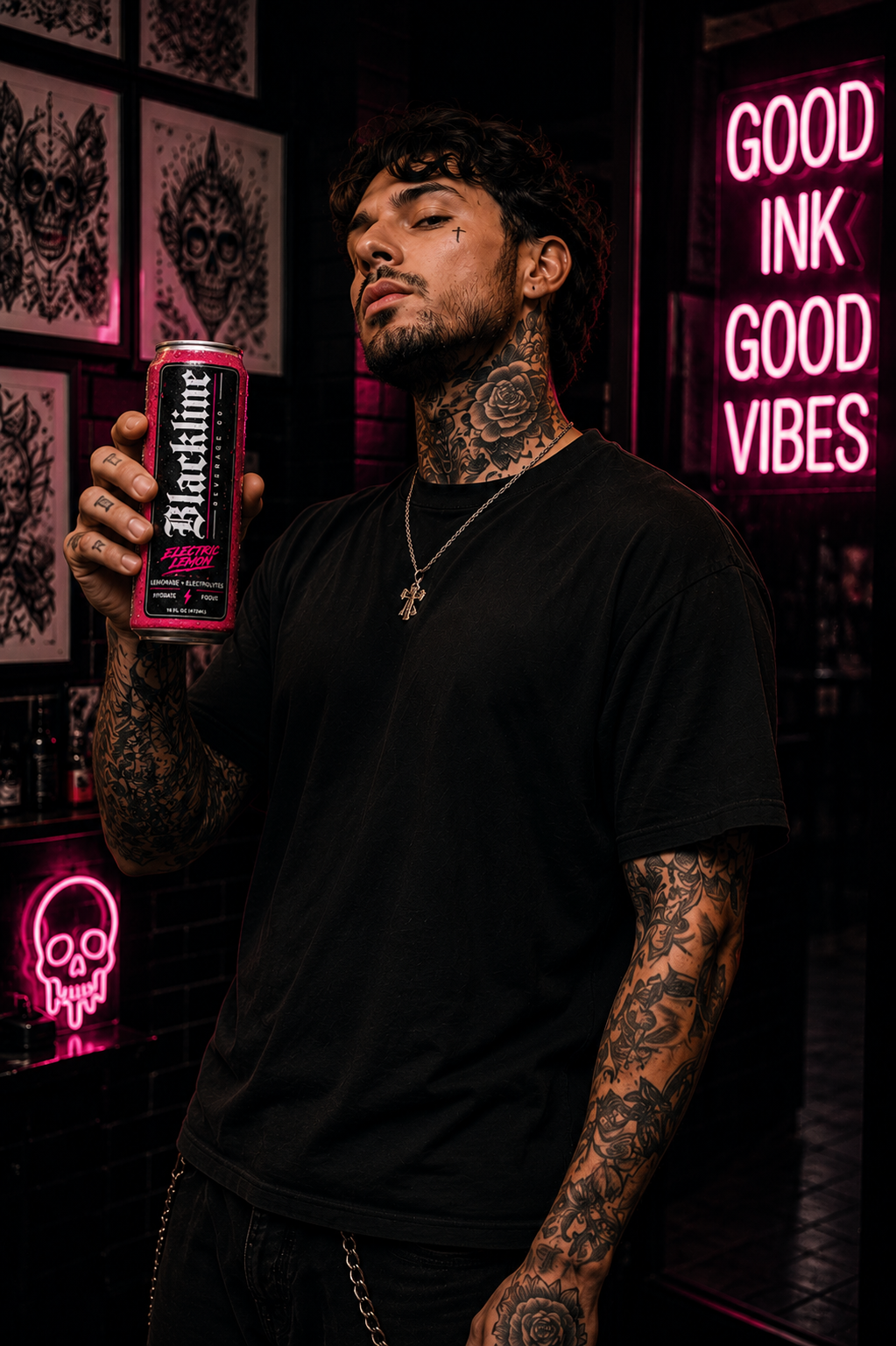 Tattooed studio client holding a Blackline Electric Lemon can beside pink neon signs